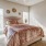 a bedroom with a bed and a fan
