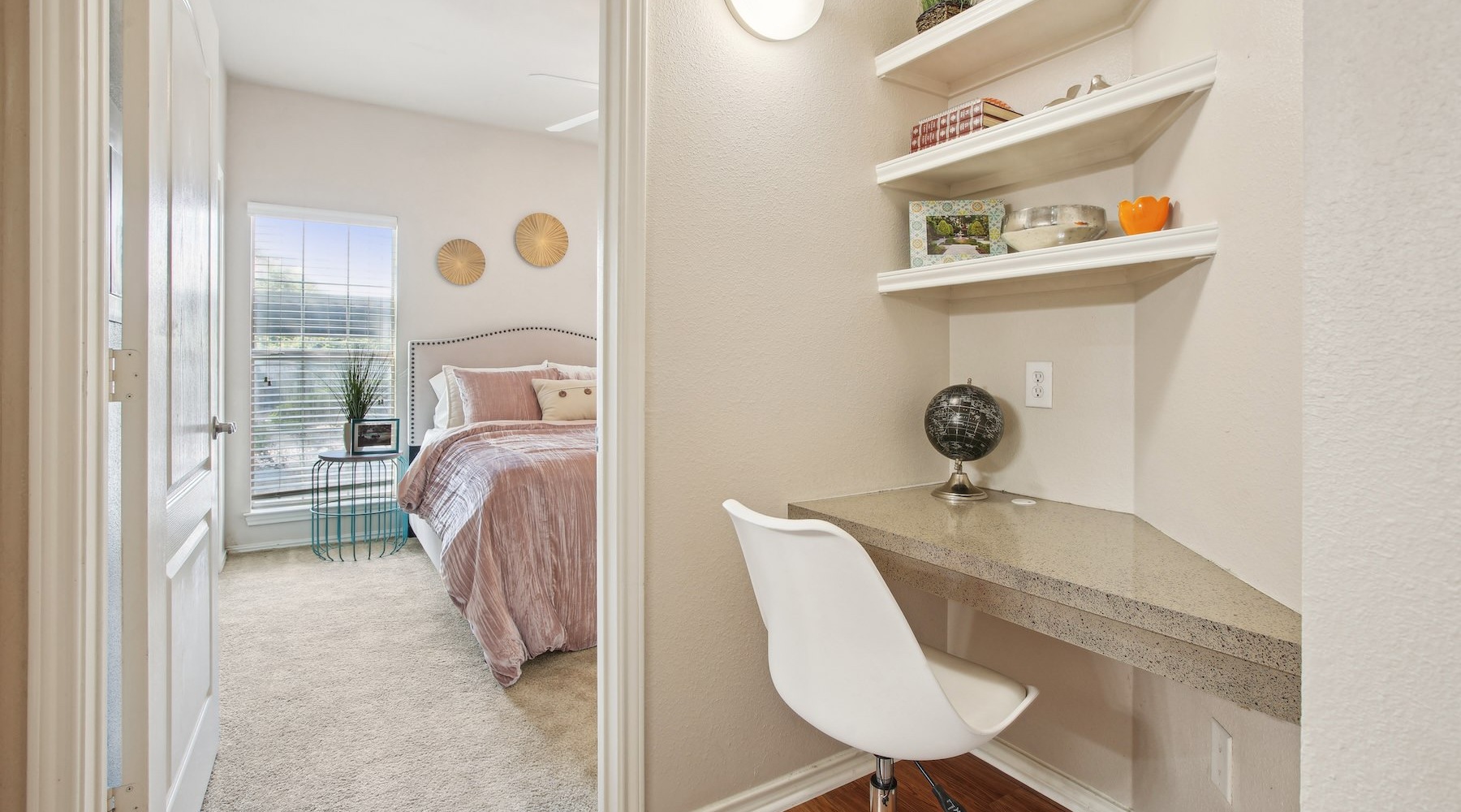 bedroom and office with a chair and shelves