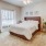 a bedroom with a bed and a fan